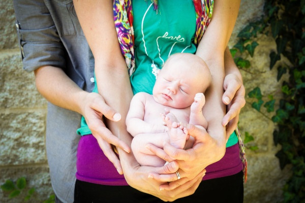 A man and woman hold the baby they adopted from Mercy Multiplied