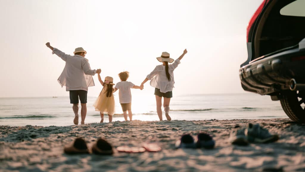 family running on the beach