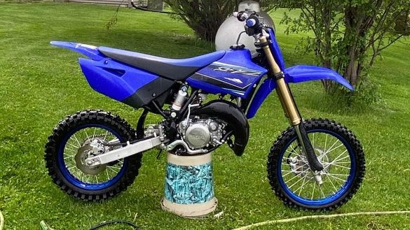 A stock 2021 Yamaha YZ85 with blue rims. Learn more about it in this review