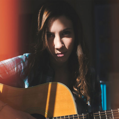 Portrait of musician holding an acoustic guitar