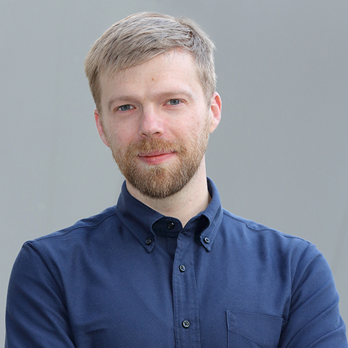 Photo of Andrew Norman wearing a blue shirt.