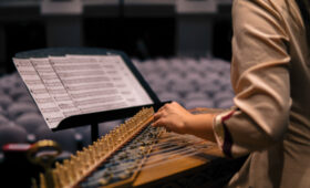 Student performs on an early music instrument.