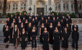 Choral students gather for a photo in front of the main library.