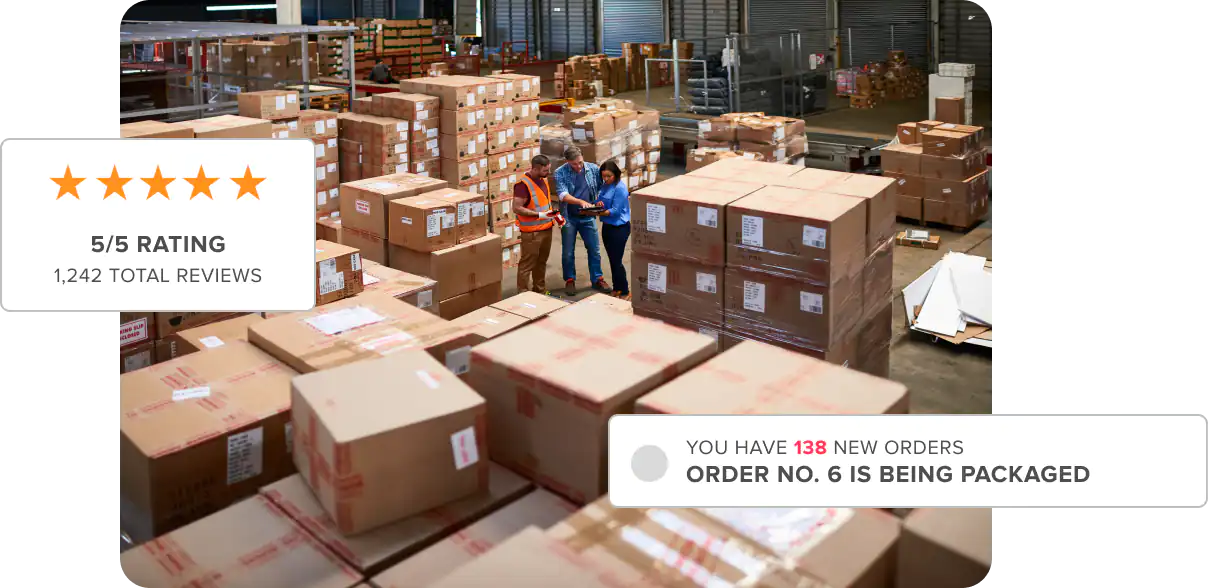 Warehouse full of cardboard boxes with group of people standing in between