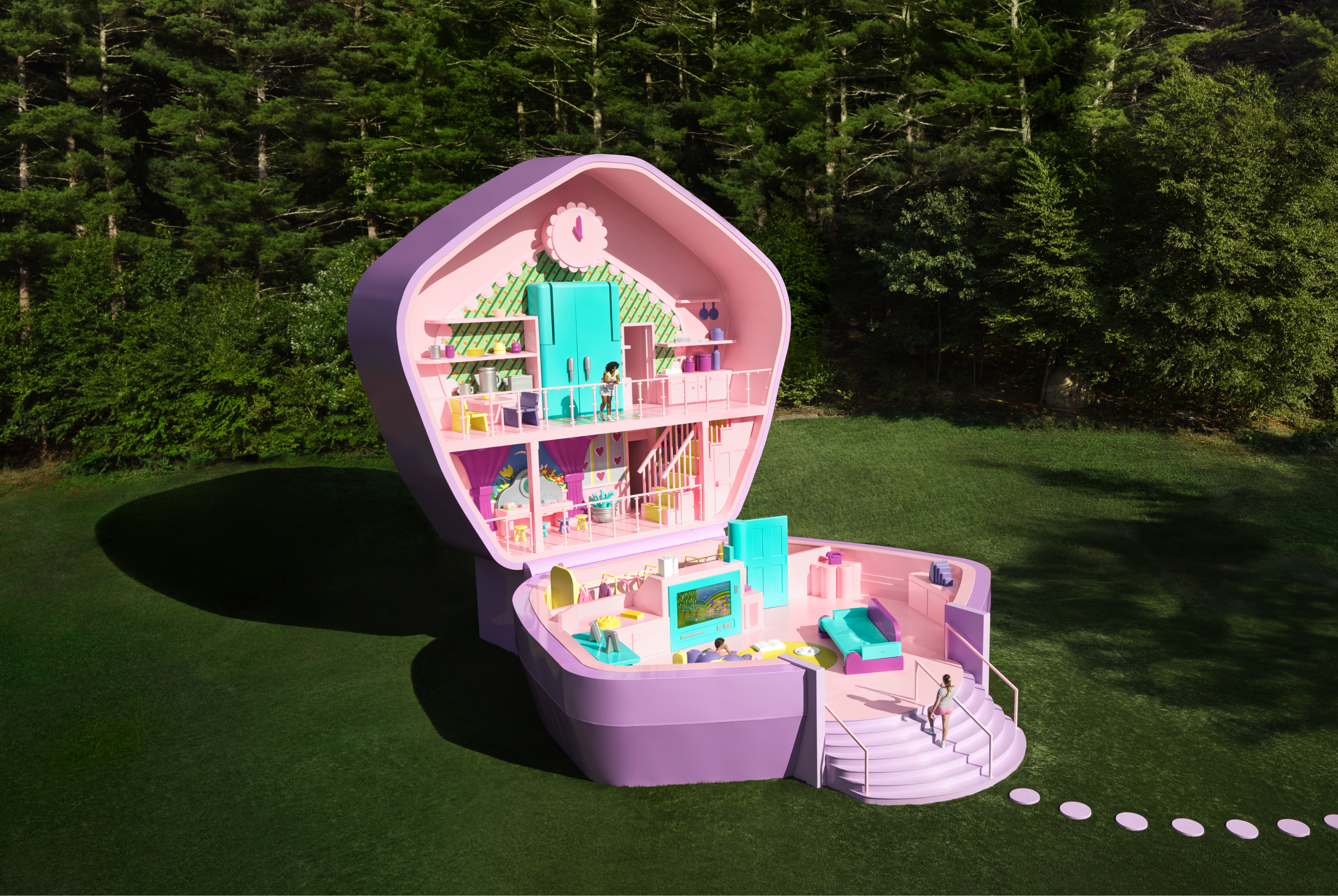 A life-sized purple Polly Pocket compact sits open in a lush green field with a forest in the background.