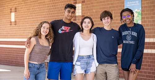 A group of MRHS students standing outside the school