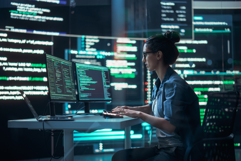 A woman coding on the computer