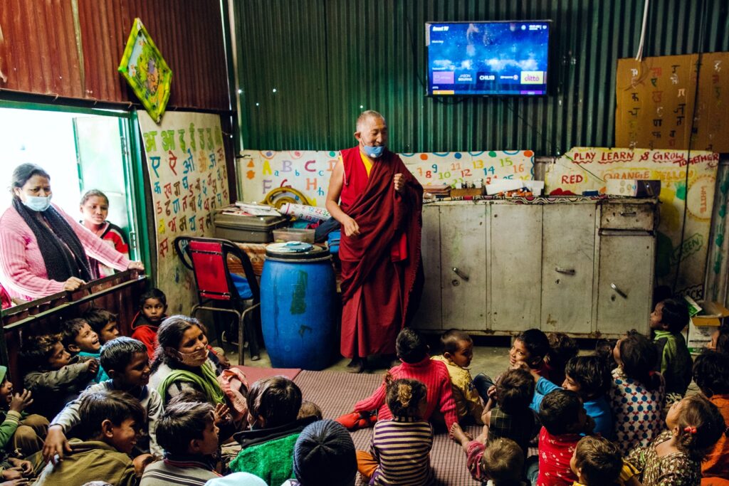 man speaking to children