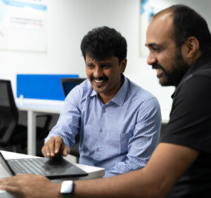 men collaborating at a laptop