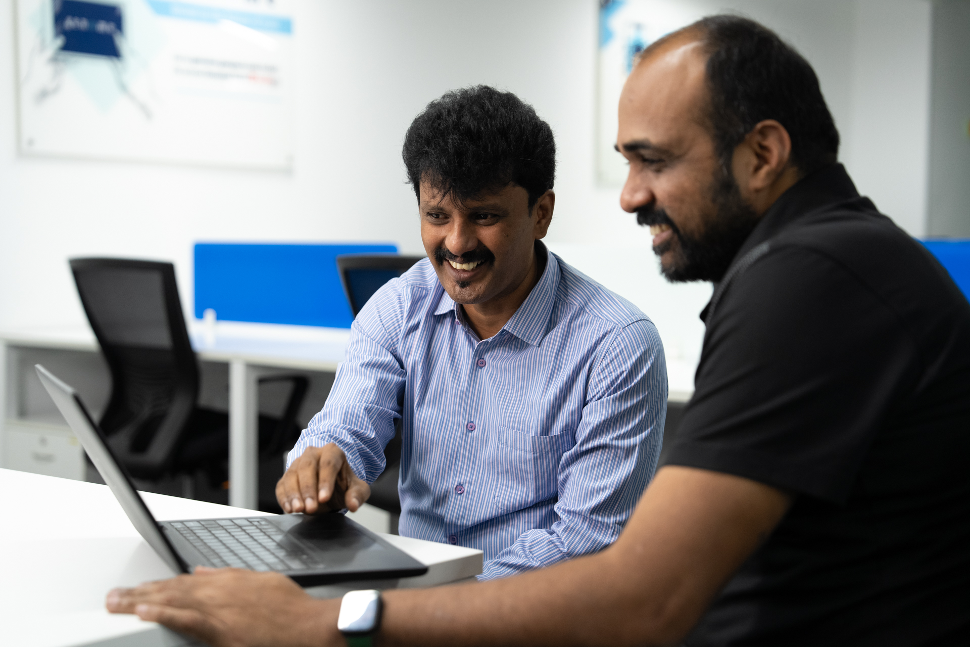 men collaborating at a laptop