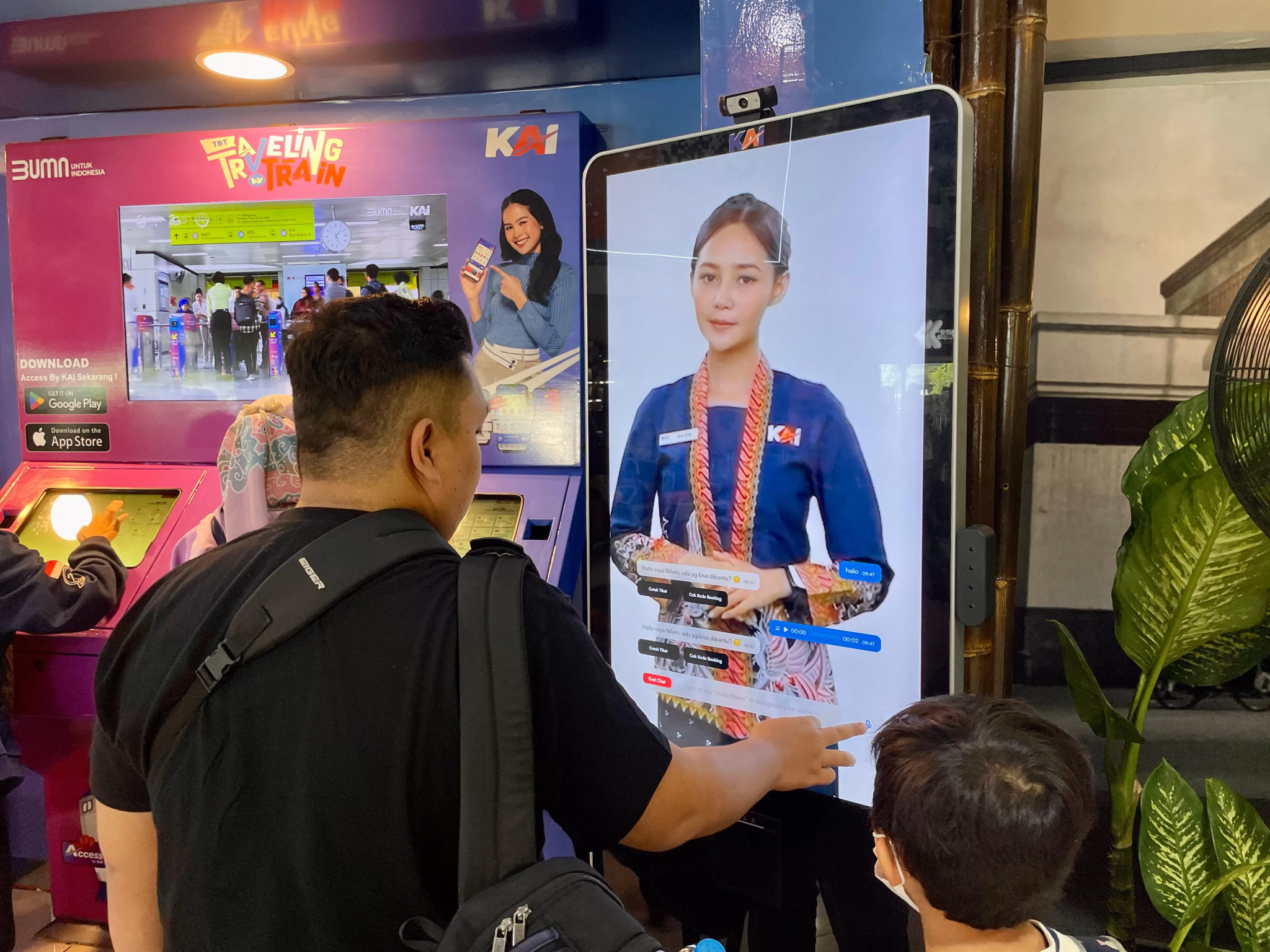 Man and child looking at a digital screen