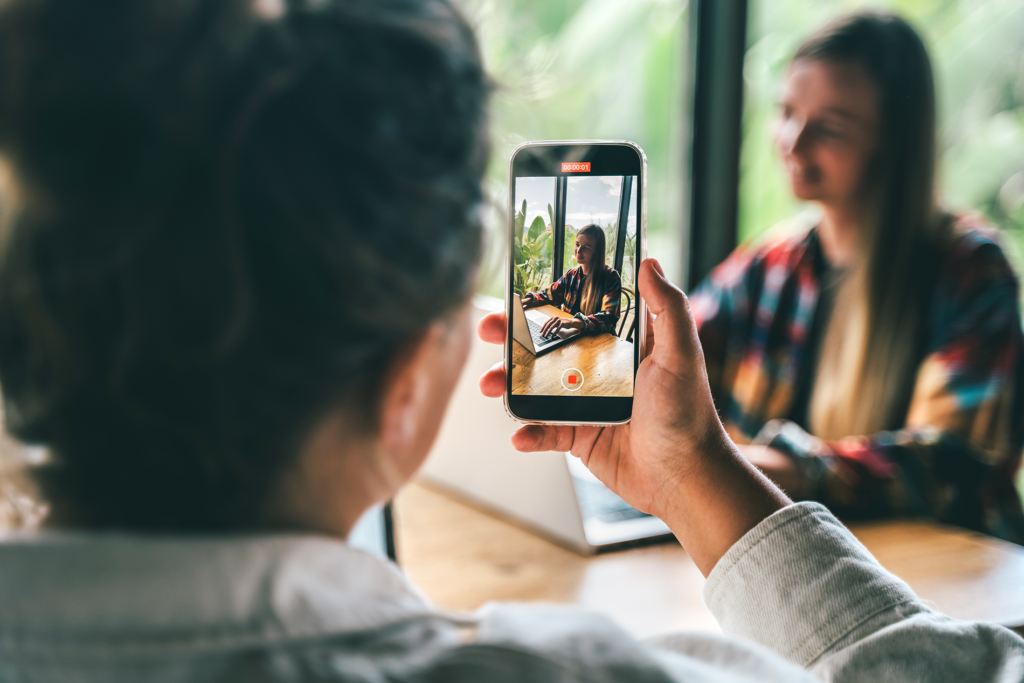 A person holds up their phone to take a picture