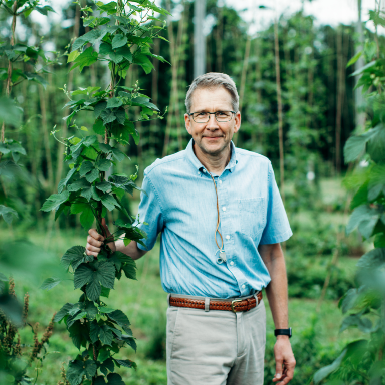 jan nyrop standing in a hop field