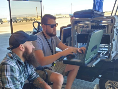 two men sitting at computer