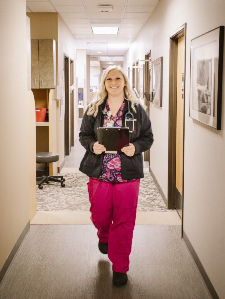 Healthcare provider walking down a hall