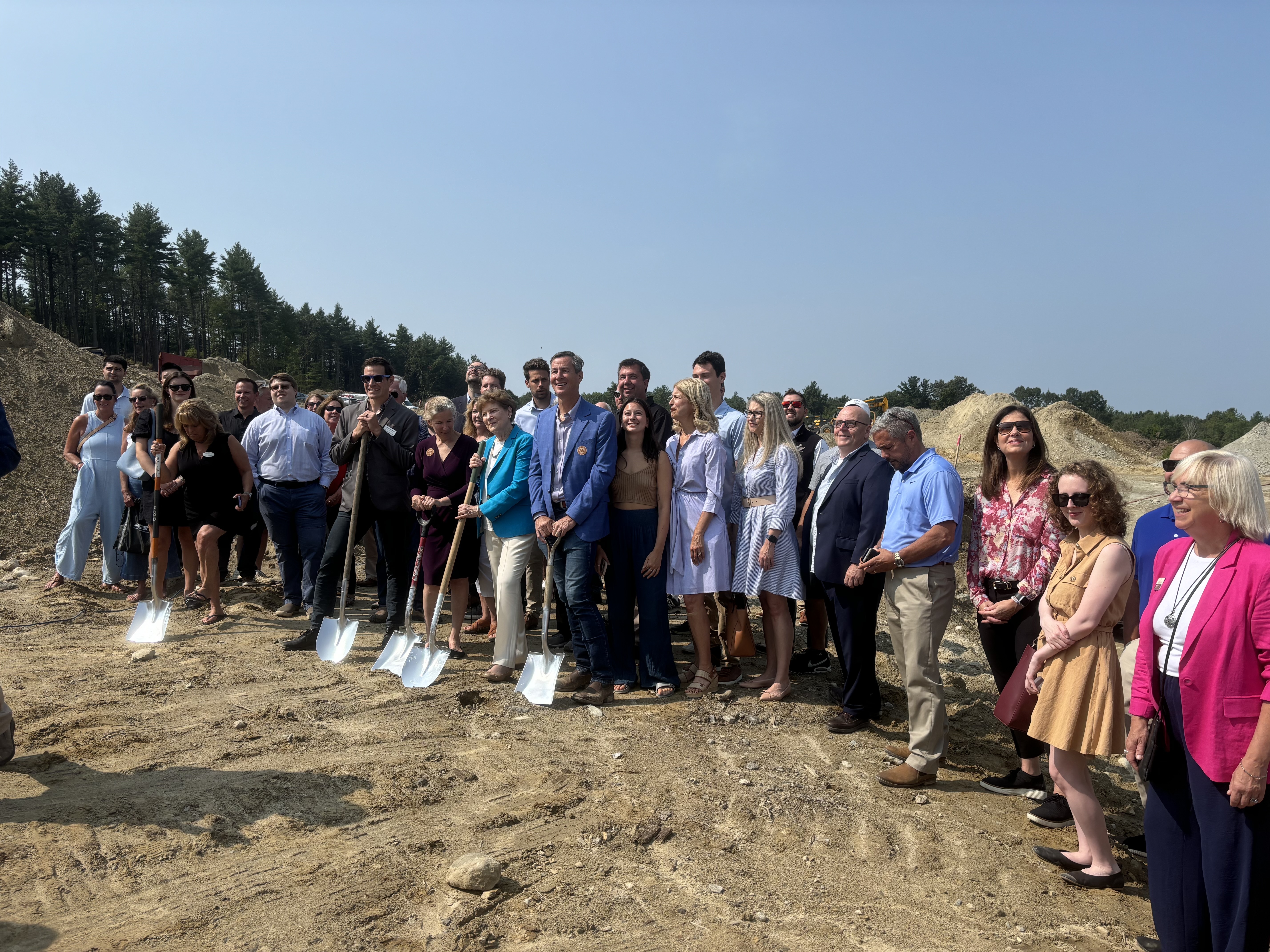 Ceremony attendees celebrate breaking ground on a new net-zero housing development in Hudson. 