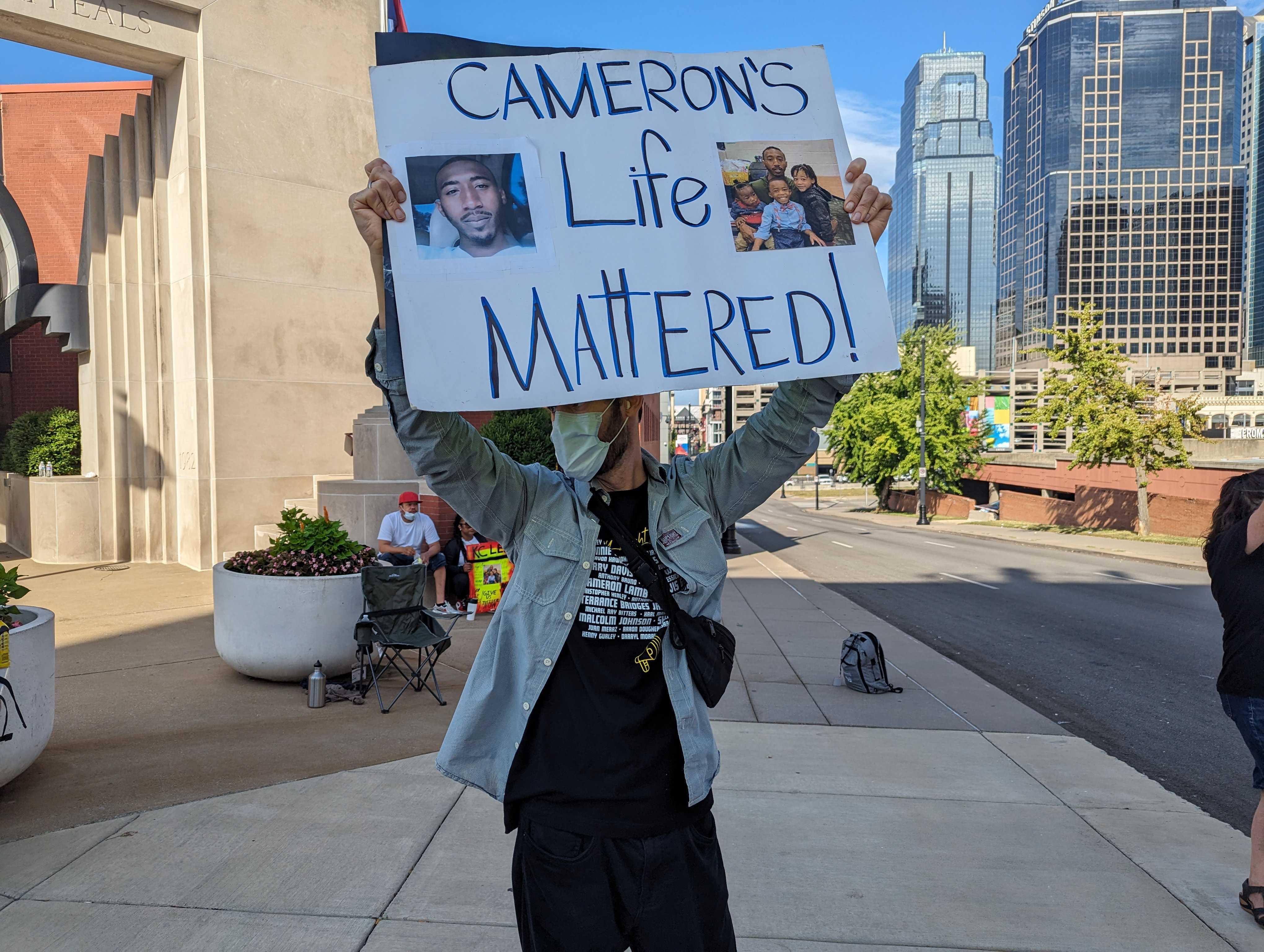 An unidentified protestor in front of the Missouri Court of Appeals in downtown Kansas City on the day the court heard oral arguments in Eric DeValkenaere's appeal of his conviction in killing Cameron Lamb.