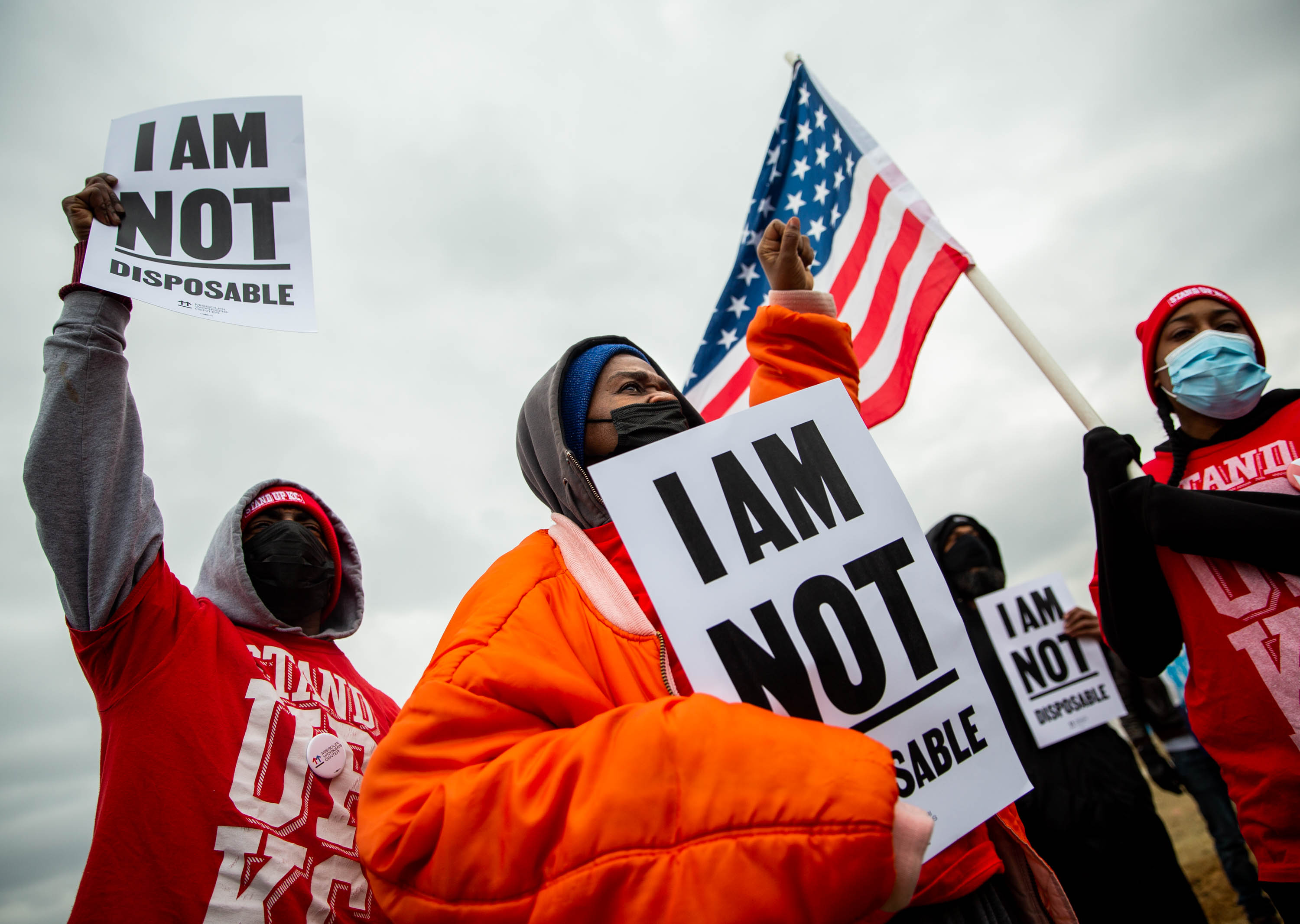 Terrence Wise, left, Sharon Parker, and Satensha Gray, all of Kansas City, chant on Thursday, Jan. 27, 2022, during a demonstration at the Amazon DS-4 Distribution Warehouse in Edwardsville, Ill. The demonstration, coordinated by the Missouri Workers Center, was to call for changes in safety protocol at Amazon facilities after a tornado partially destroyed the Edwardsville hub last month, killing six workers.