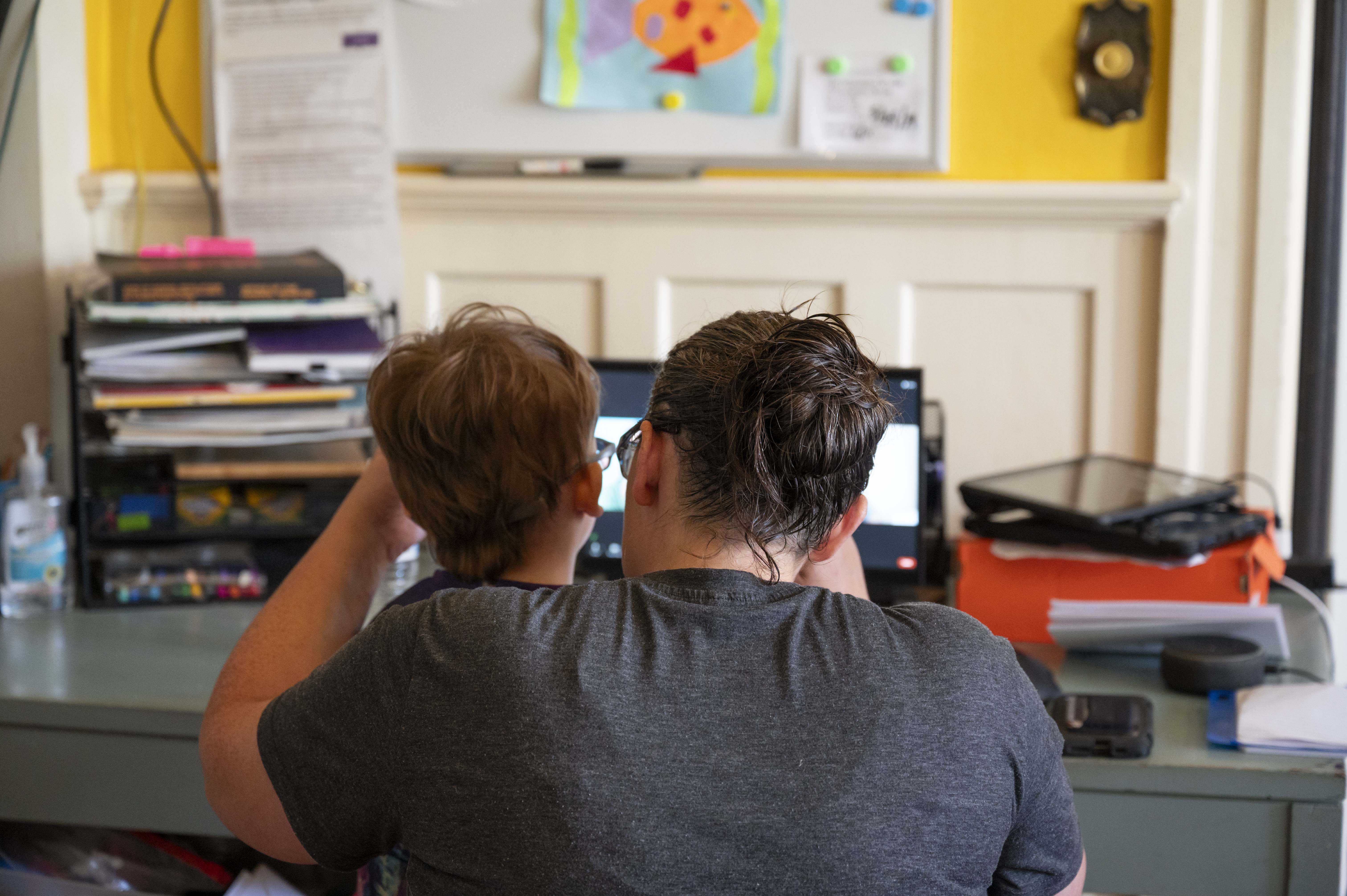 Six-year-old Sam and his mother, Tabitha, attend a virtual class with Sam’s teacher of the deaf and hard of hearing.