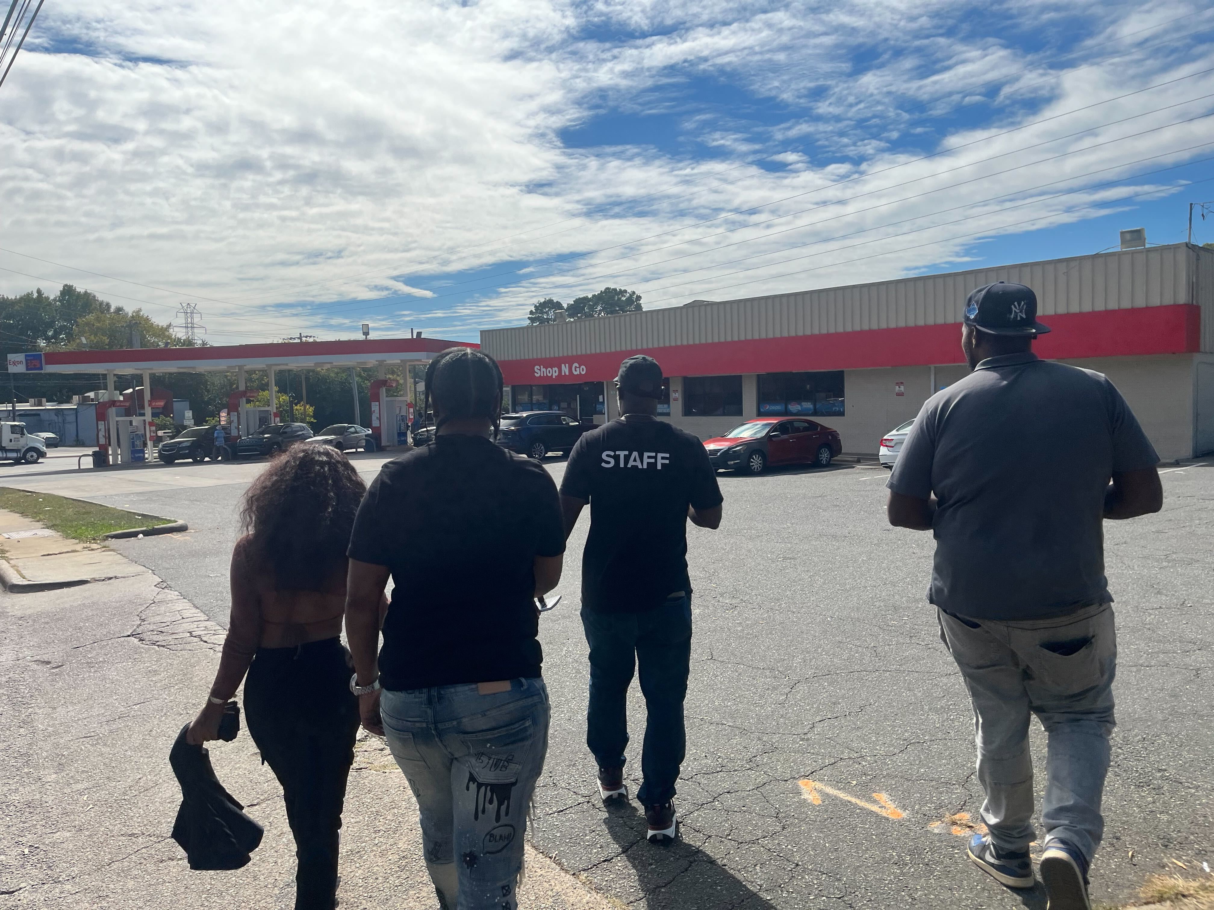 From left: Dayja Garrett, Tyesha Littlejohn, Donnell Gardner, and James Love hand out leaflets about the Alternatives to Violence program along West Boulevard.