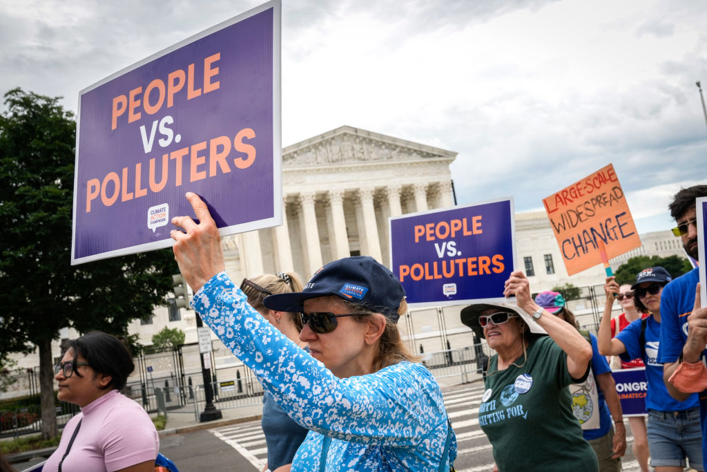 Environmental activists rally in front of the U.S. Supreme Court in 2022 after it ruled against the Obama administration's plan to cut climate-warming emissions at the nation's power plants. The Supreme Court has since further limited the power of federal agencies like the Environmental Protection Agency.