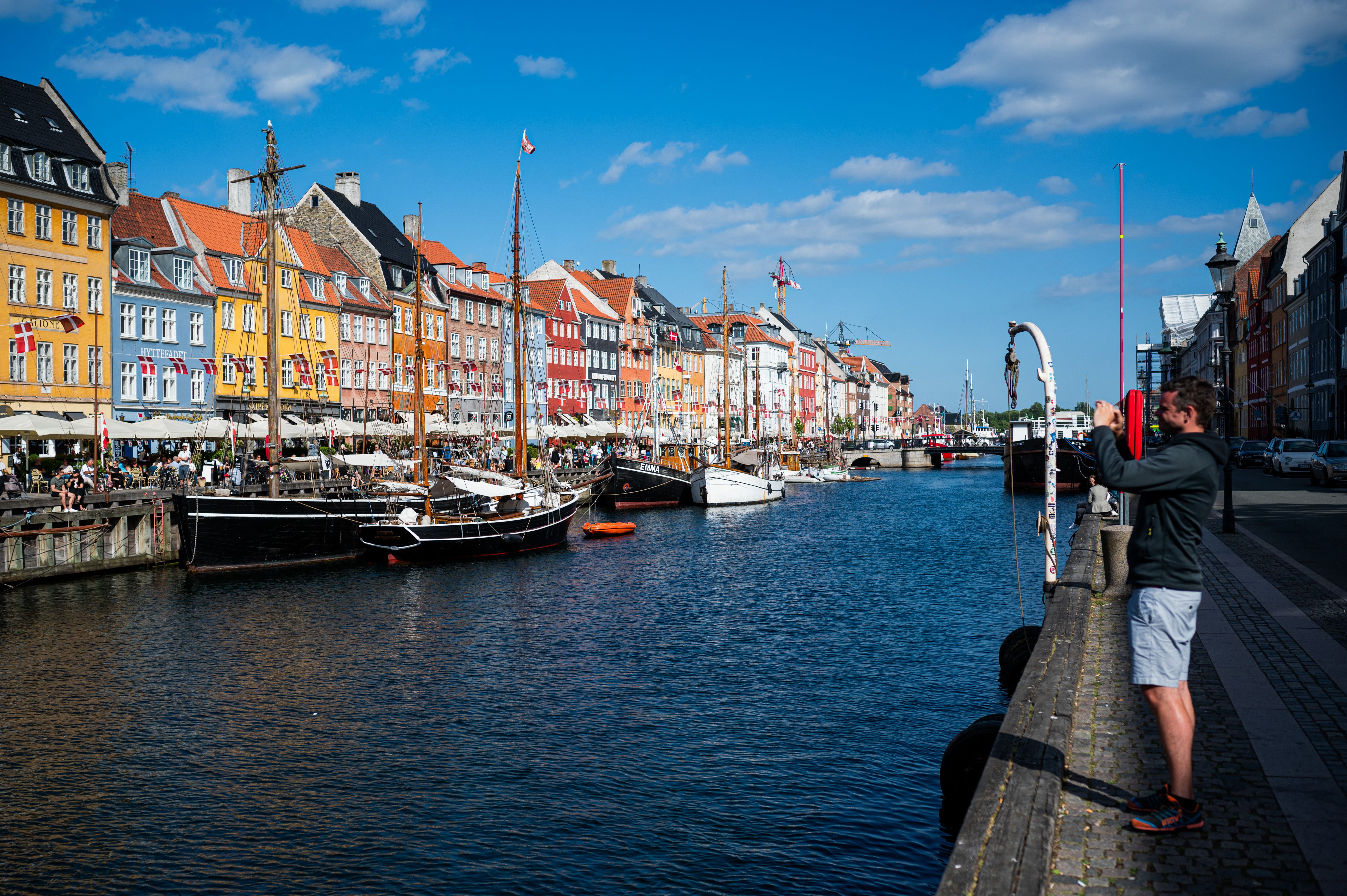 Tourists visit Nyhavn, the 17th-century waterfront, in Copenhagen, Denmark, in this 2021 file photo.