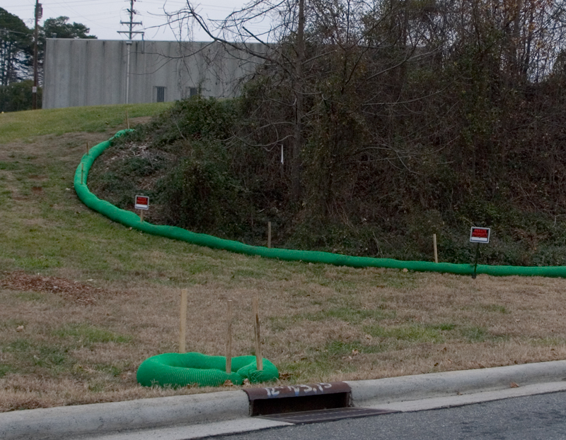 Green "filter socks" are designed to control runoff behind the old Carolina Asbestos plant in Davidson.  The trees will be removed and the hill full of asbestos covered starting next week. 