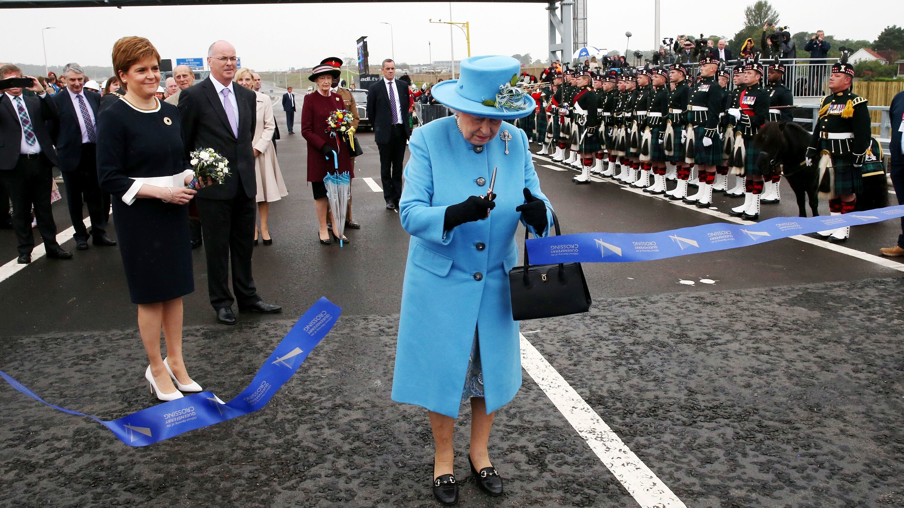 Queen Elizabeth II cuts the ribbon during the 2017 opening ceremony for the Queensferry Crossing.