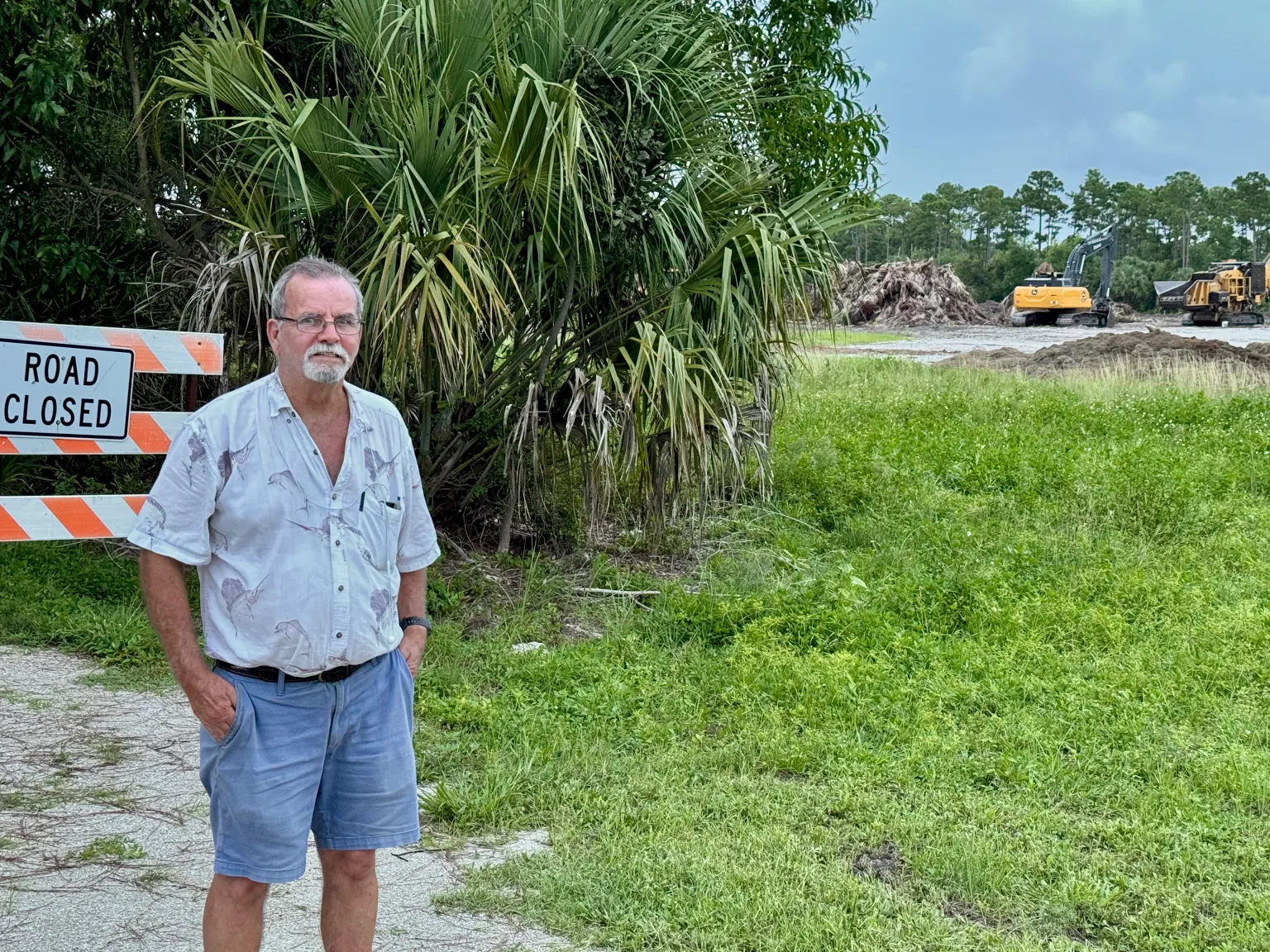 Paul Cameron stands next to the closed nature trail, left, with the cleared forest to his right at the Gardens North County District Park.