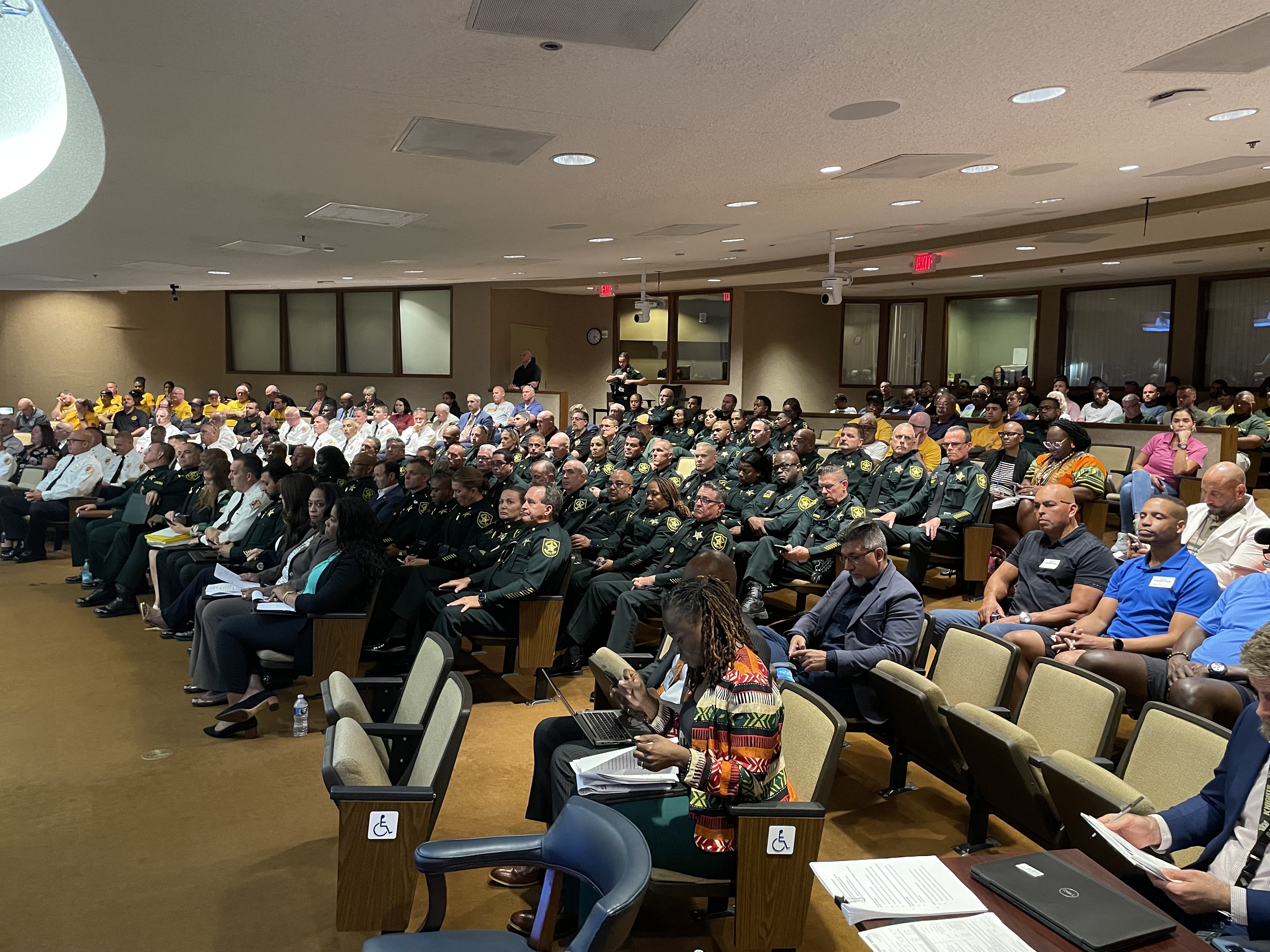 A commission chamber full of uniformed officers