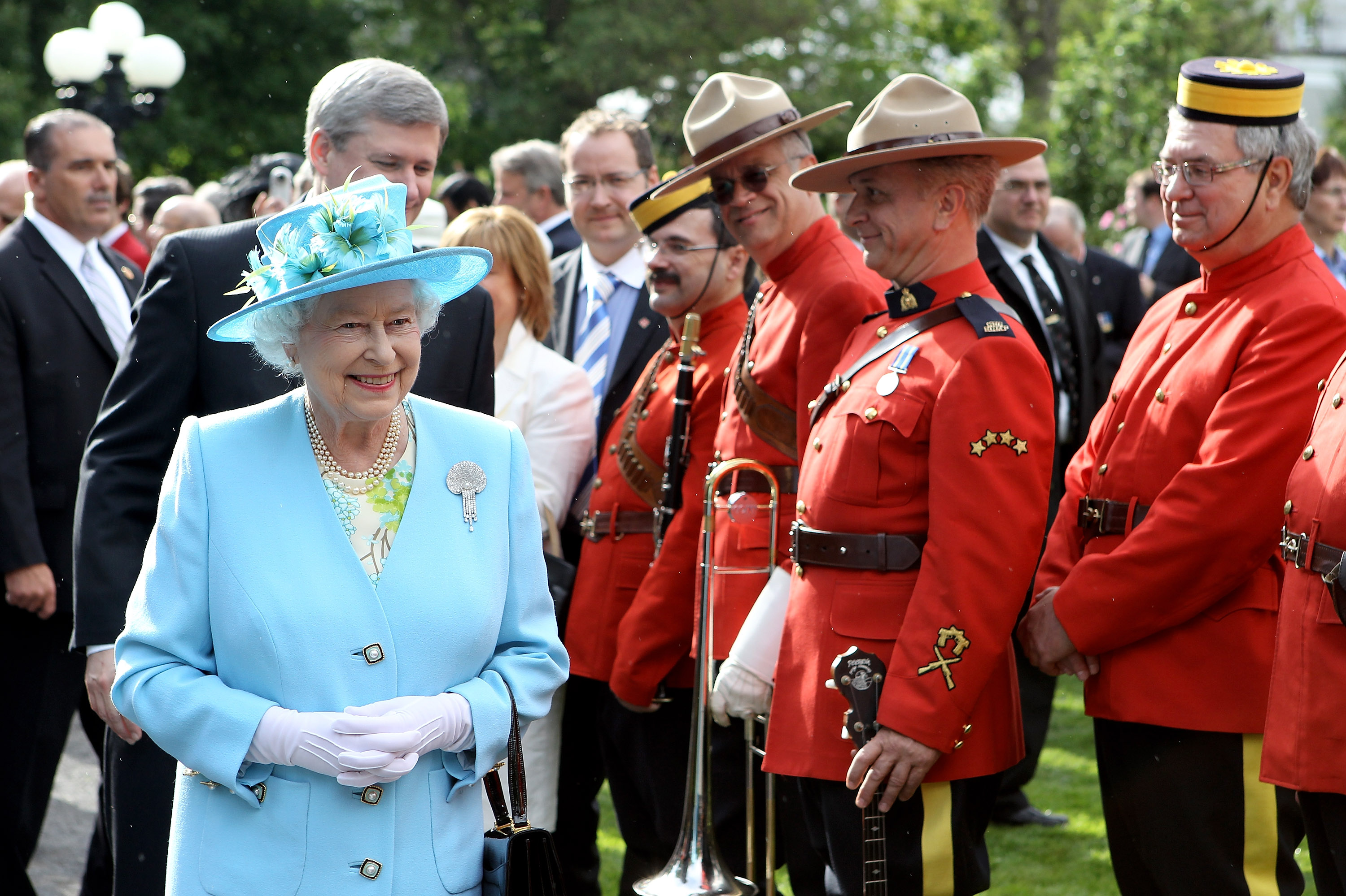 Queen Elizabeth II, followed by then-Canadian Prime Minister Stephen Harper, attends a garden party at Government House on June 30, 2010, in Ottawa, Canada.