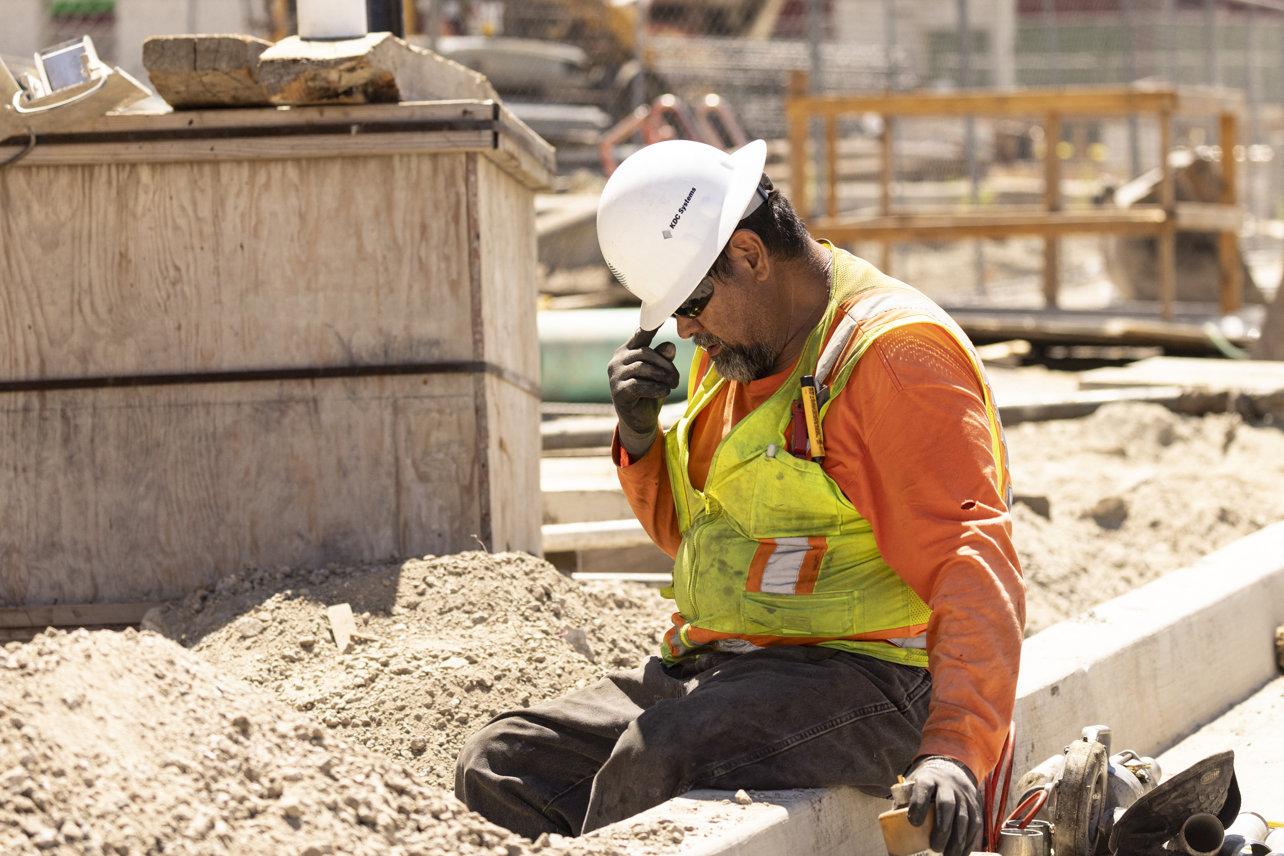 A worker adjusts his helmet on a construction site under the sun as southern California faces a heat wave, in Los Angeles, on Wednesday.