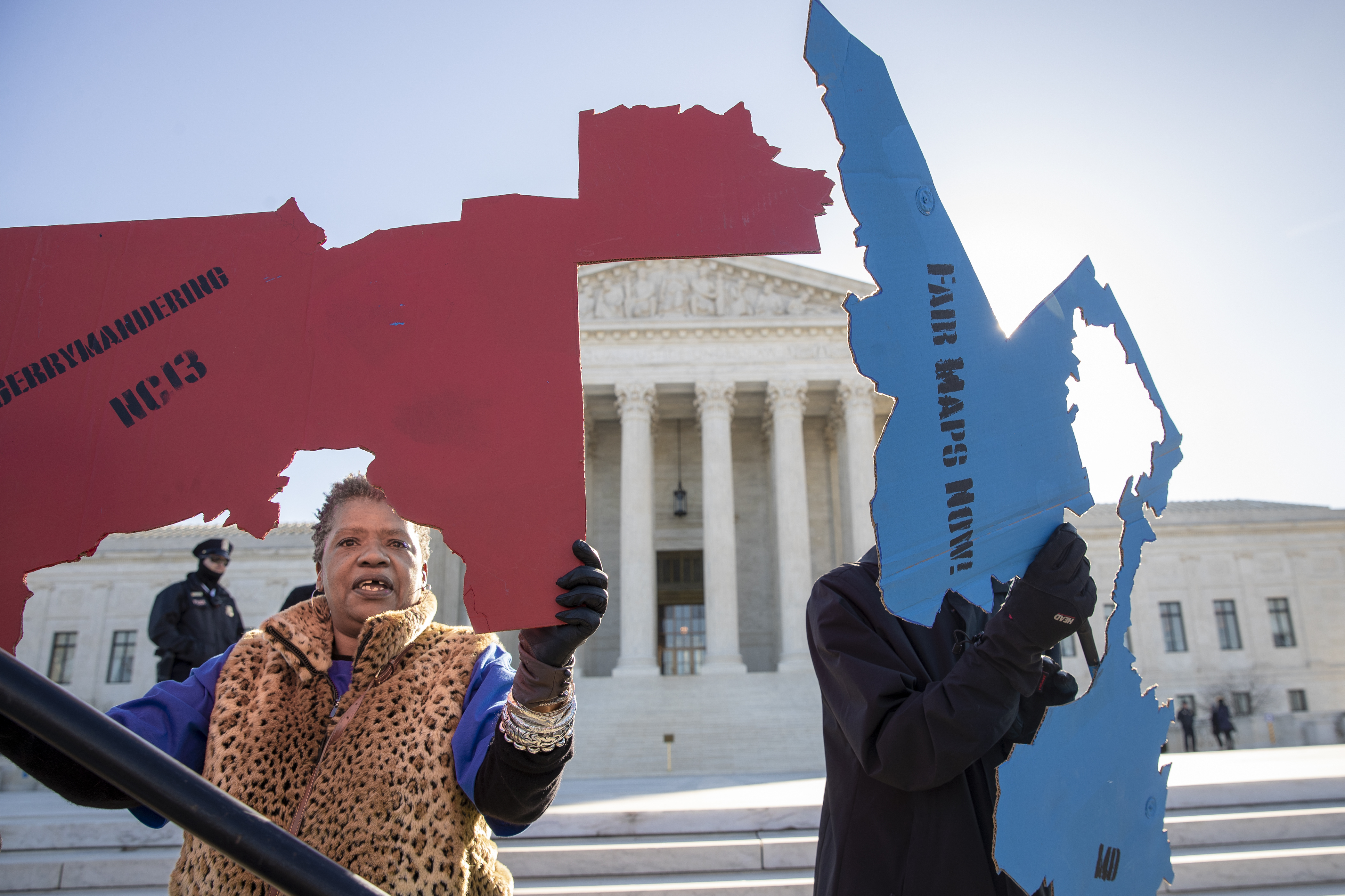 Activists at the Supreme Court opposed to partisan gerrymandering hold up representations of congressional districts from North Carolina, left, and Maryland, right, as justices hear arguments about the practice of political parties manipulating the boundary of a congressional district to unfairly benefit one party over another, in Washington, Tuesday, March 26, 2019. Democrats and Republicans eagerly await the outcome of cases from Maryland and North Carolina because a new round of redistricting will follow the 2020 census, and the decision could help shape the makeup of Congress and state legislatures over the next decade. 