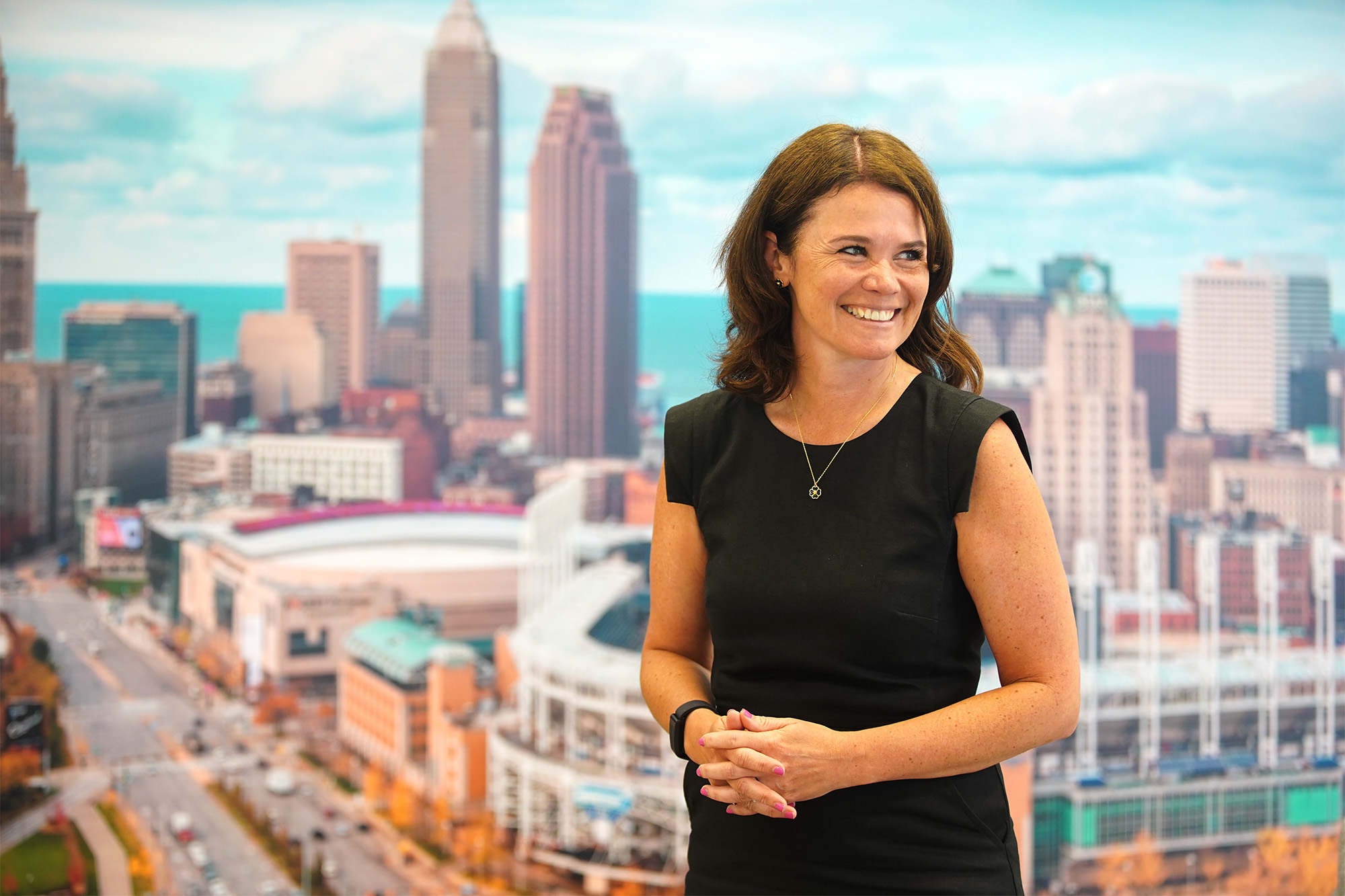 Impressia Bank President Mary Kate Loftus stands for a photo in front of a mural of Downtown Cleveland inside the bank's regional headquarters in Seven Hills, Ohio.