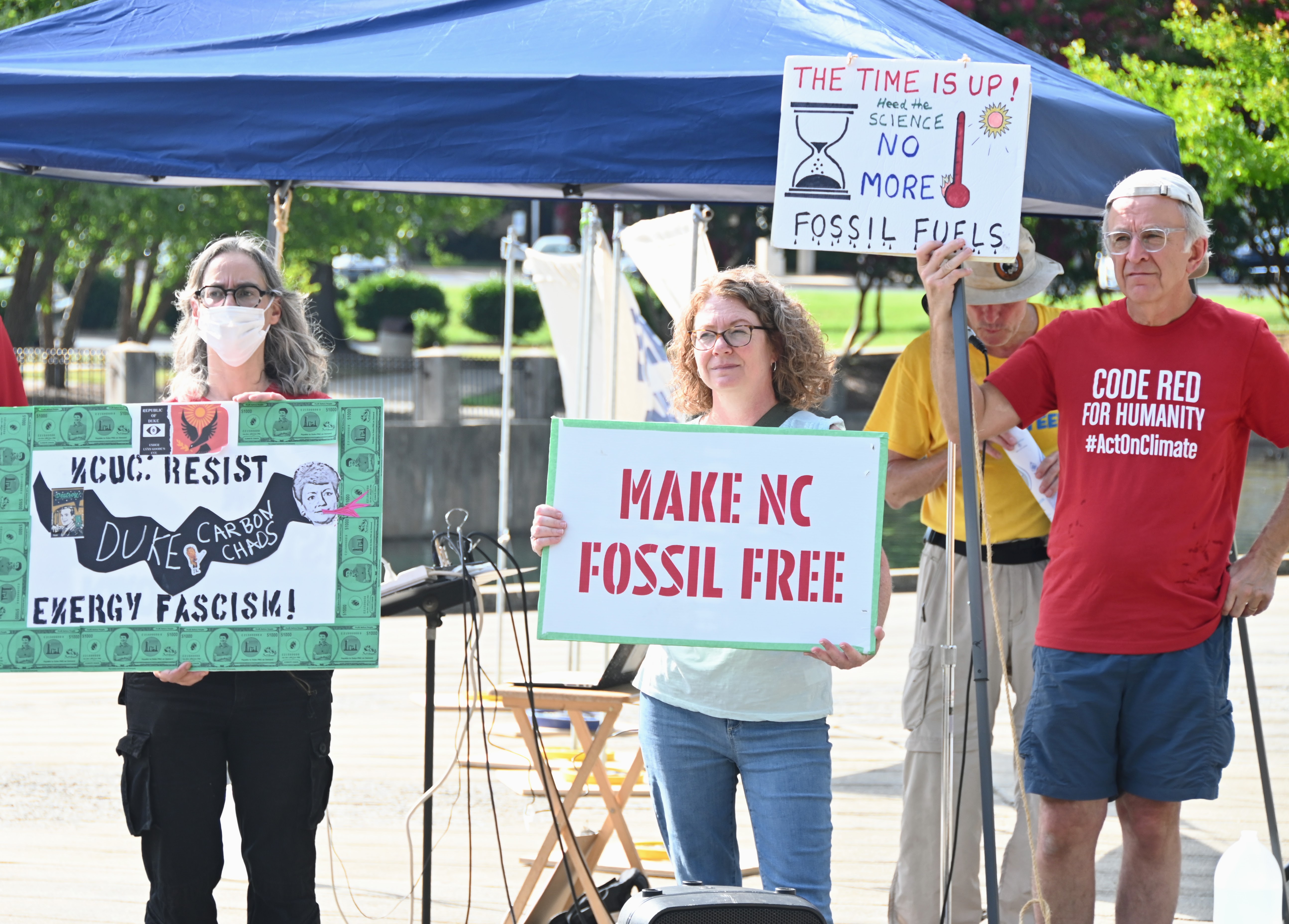 Participants held signs at Thursday's climate rally at Marshall Park.