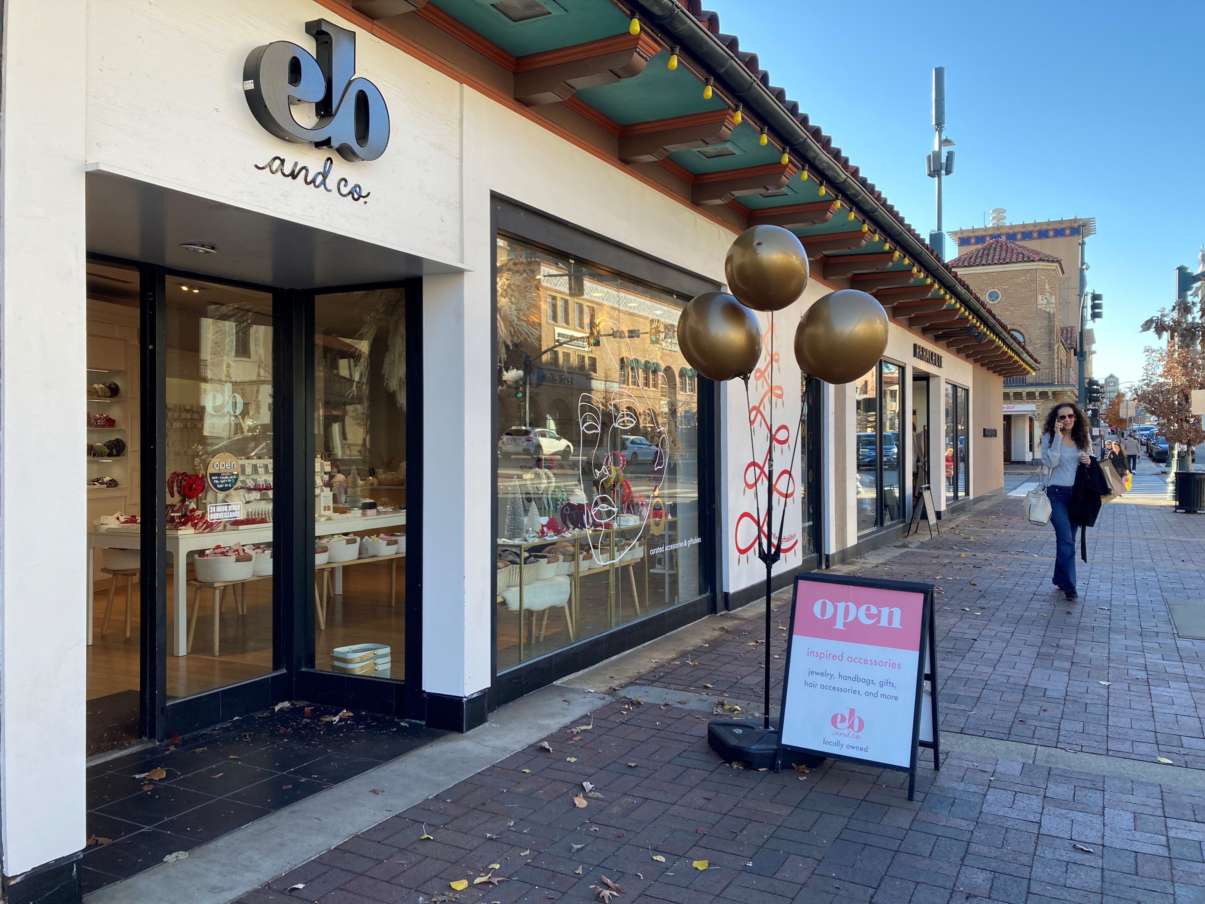 A shopper walks by the EB & Co. store on the Country Club Plaza on December 7, 2023.