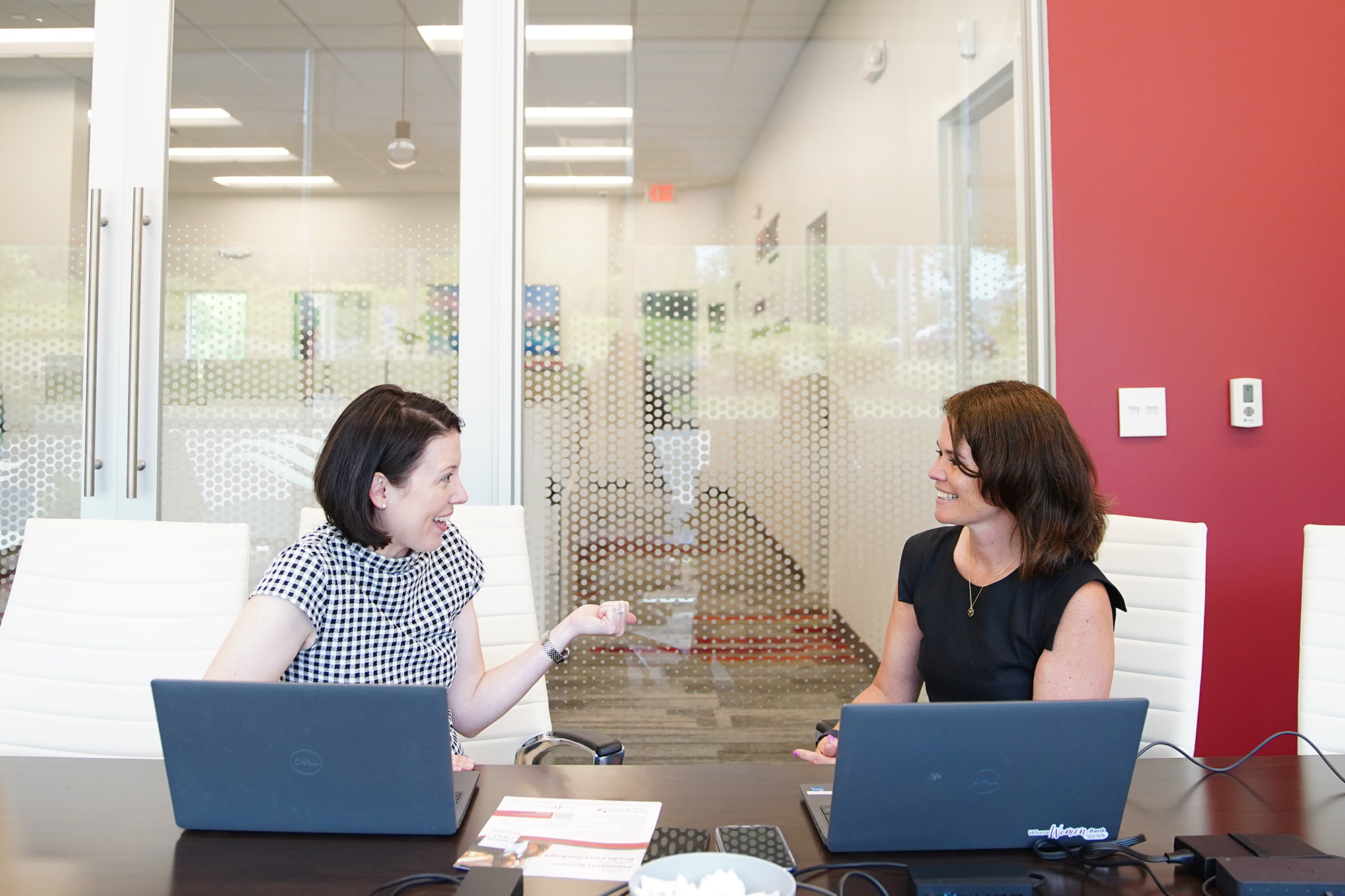 Impressia Bank President Mary Kate Loftus (right) chats with Martha Seidenwand, Impressia's vice president, on Monday, June 17, 2024, at the bank's regional headquarters in Seven Hills, Ohio. Impressia Bank, a division of CNB Bank created and managed by women, launched in May 2023. Its headquarters are co-located with CNB sister division ERIEBANK.