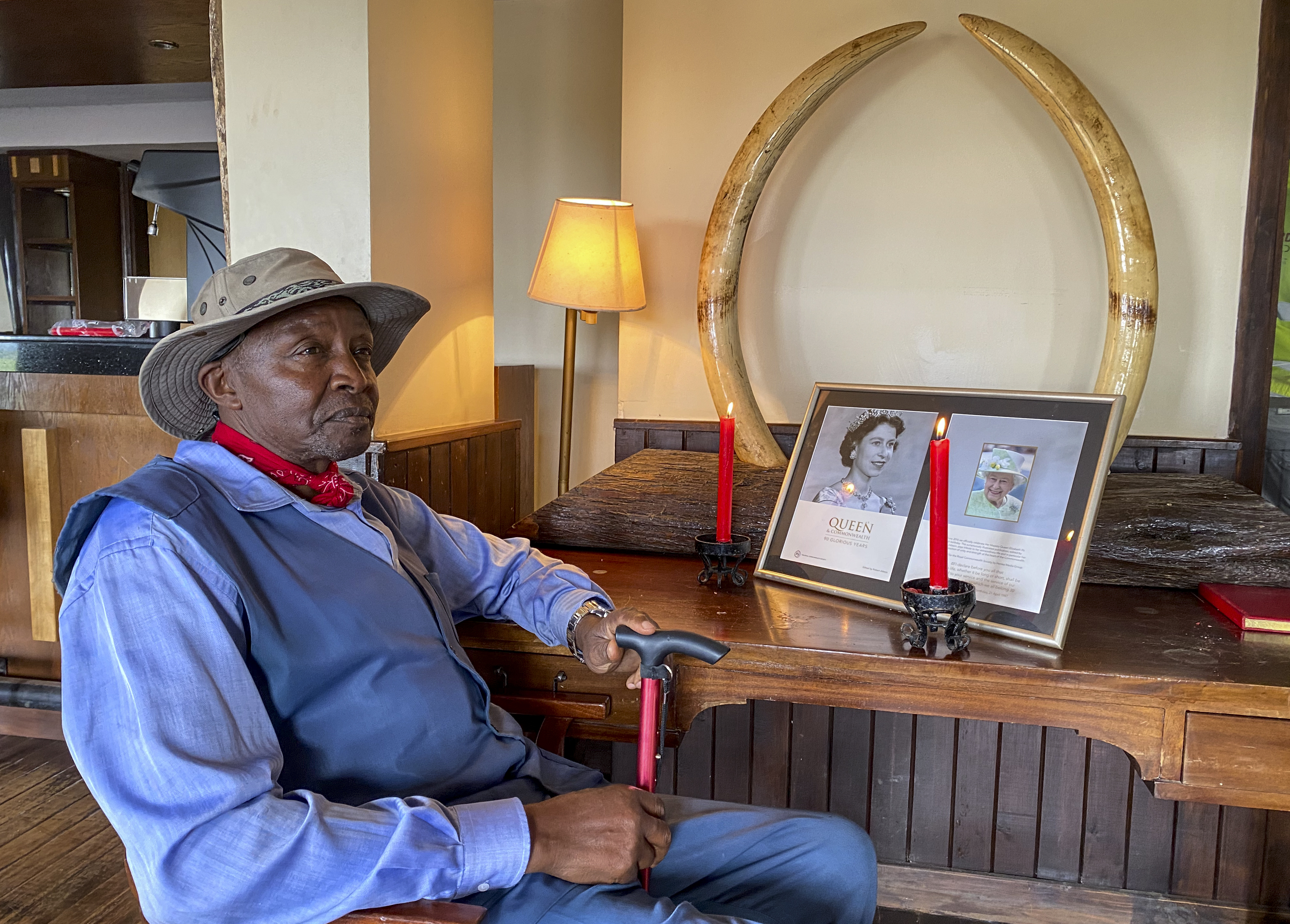 Amos Ndegwa, a naturalist and tour guide, lights a candle to pay tribute in the lounge of the Treetops Hotel in Kenya, where Britain's Queen Elizabeth II spent her last night as a princess. The hotel, in Kenya's Aberdare National Park, closed because of declining tourism during the coronavirus pandemic.