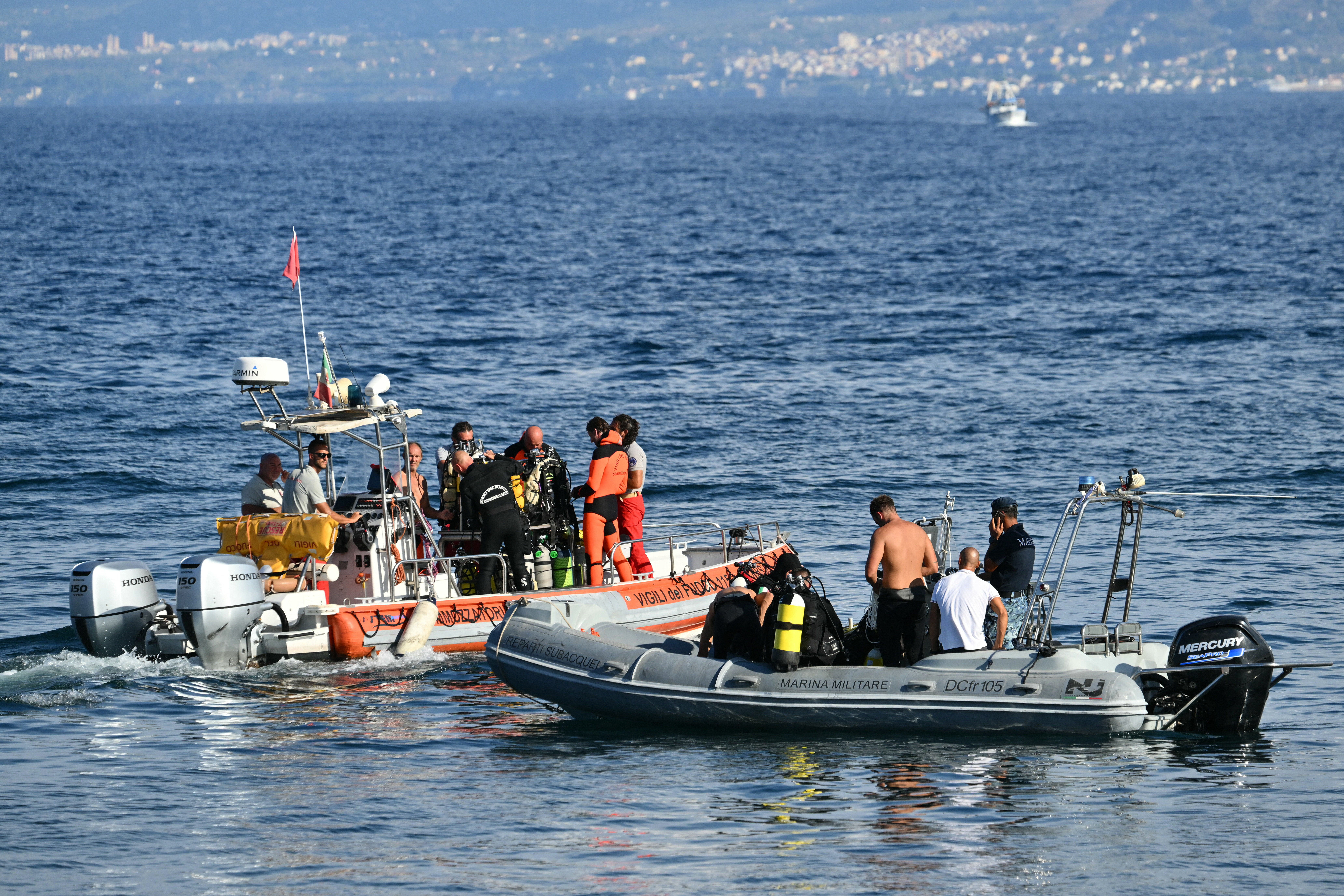 Dive and recovery teams search for a final missing person off Porticello harbor near Palermo on Aug. 22, three days after the British-flagged luxury yacht Bayesian sank.