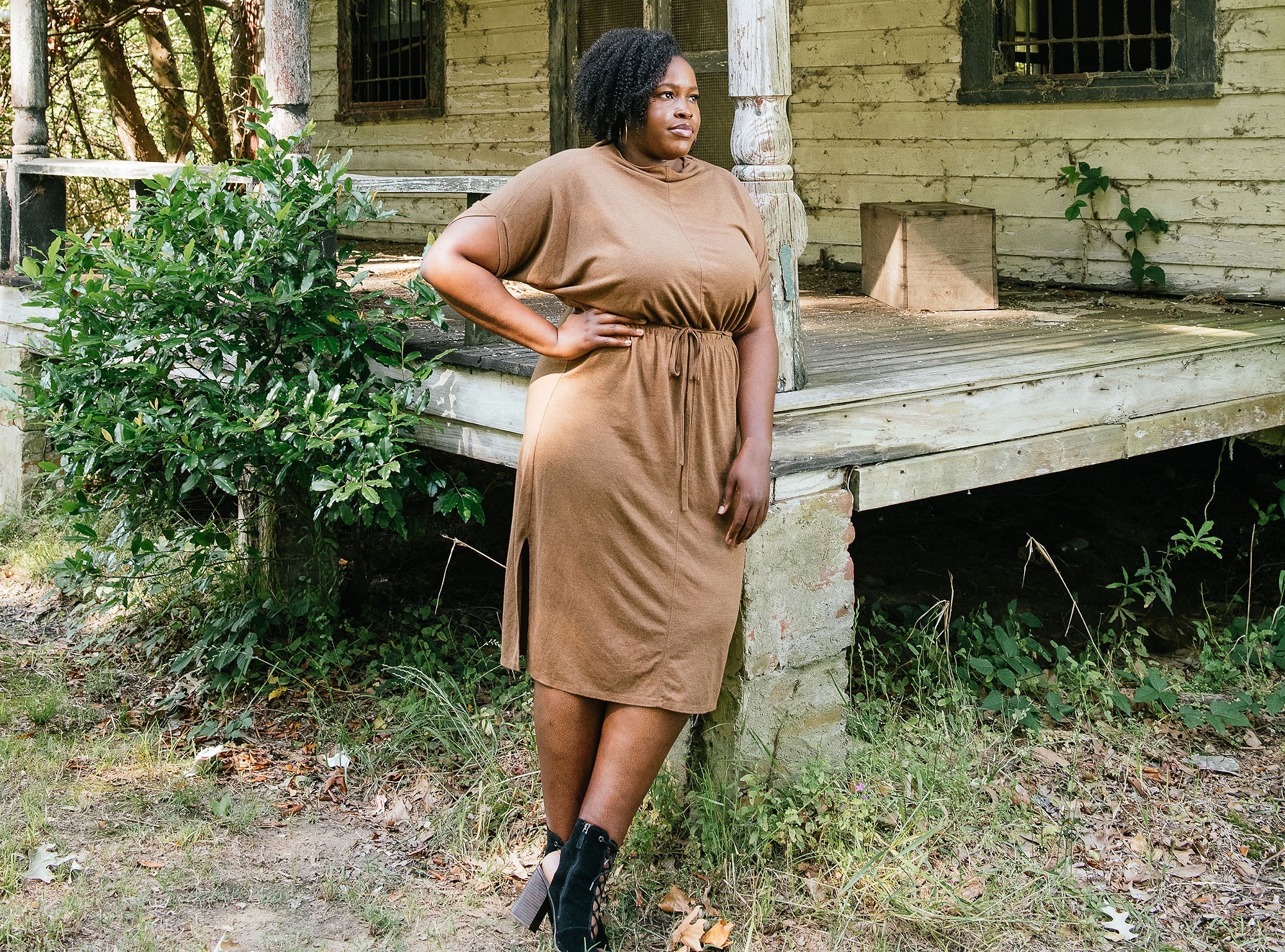 Mika Gadsden stands outside a house with a porch