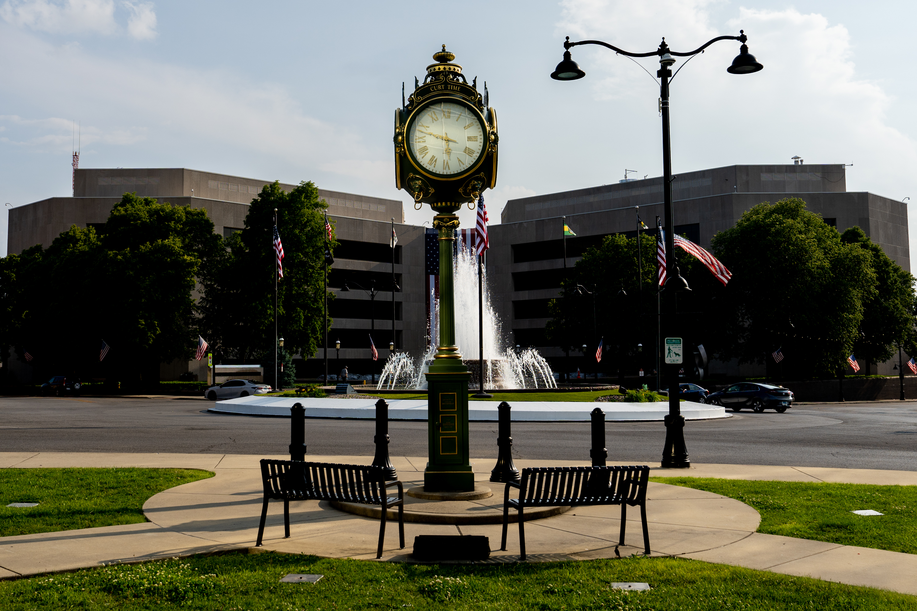 A clock dedicated to Curt Weisenstein frames the St. Clair County Administration Building on Tuesday, May 23, 2023, in Belleville. Weisenstein was a man who disabled by a brain injury at birth and died at age 69 due to cancer. In life, he was familiar to the business owners in downtown Belleville, according to reports. He was known to help people set their watches and clocks, while keeping an eye on clocks in the businesses he visited daily.