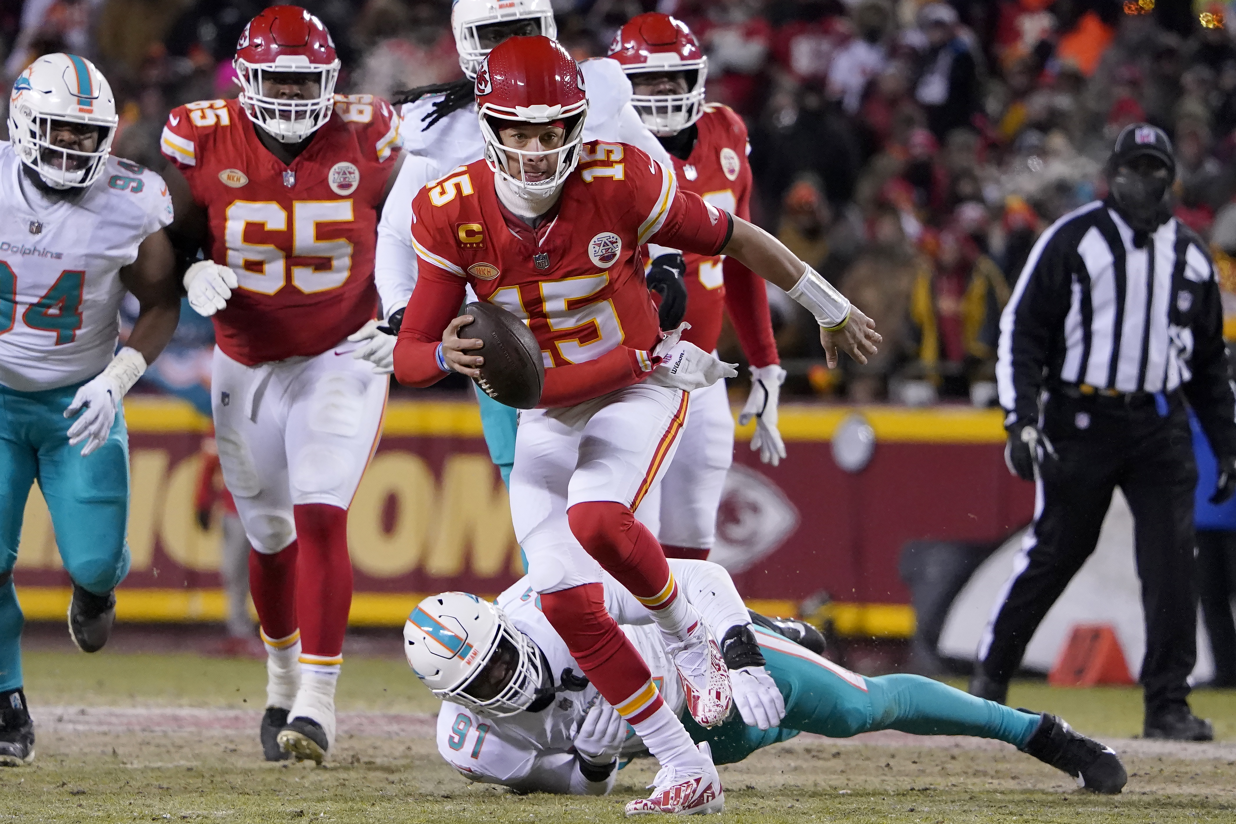 Kansas City Chiefs quarterback Patrick Mahomes runs in front of Miami Dolphins defensive end Emmanuel Ogbah during the first half of the wild-card playoff football game Jan. 13 in Kansas City. The Chiefs won, and will face the Buffalo Bills on Sunday evening.