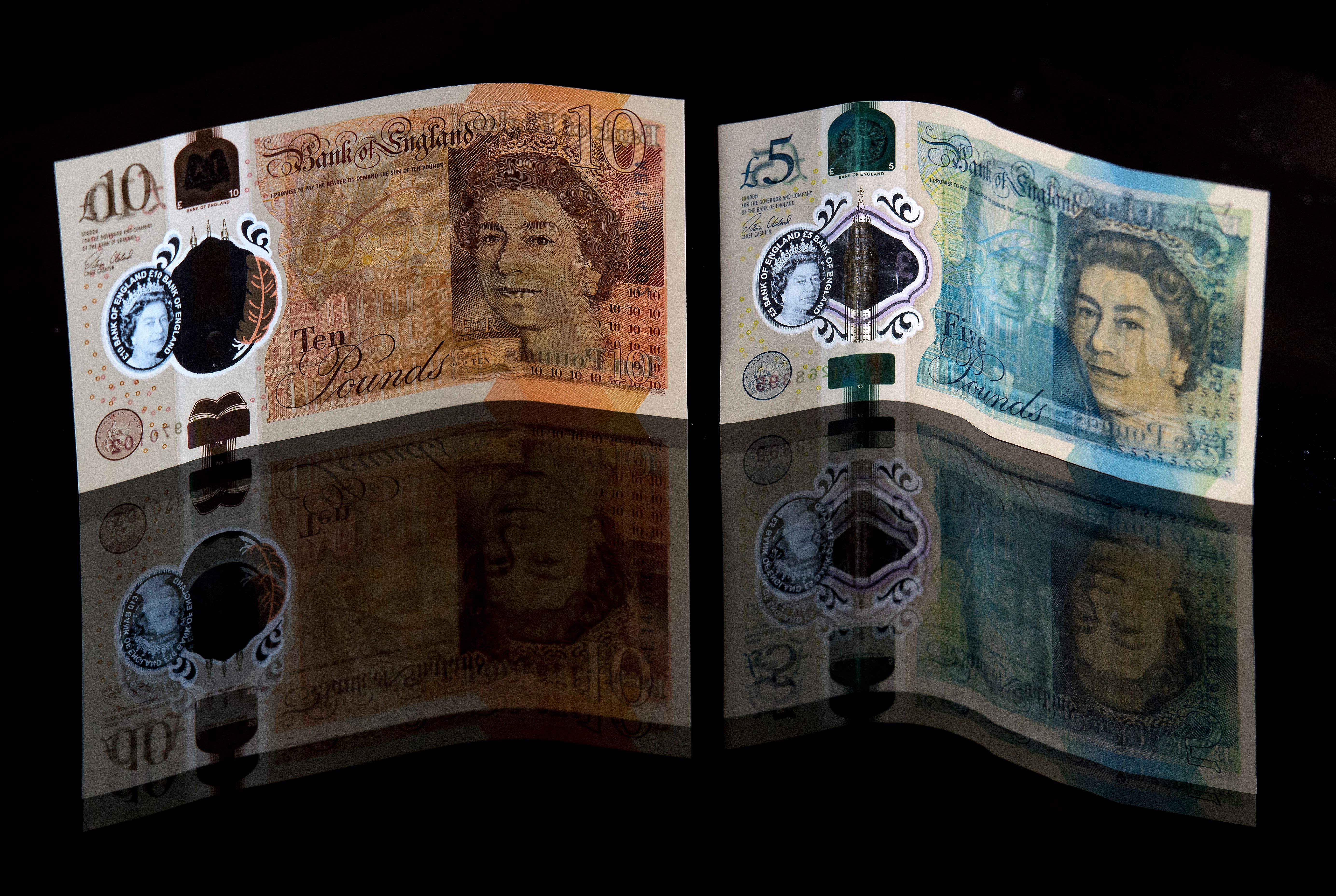  British 10-pound sterling and five-pound sterling note are arranged for a photograph.