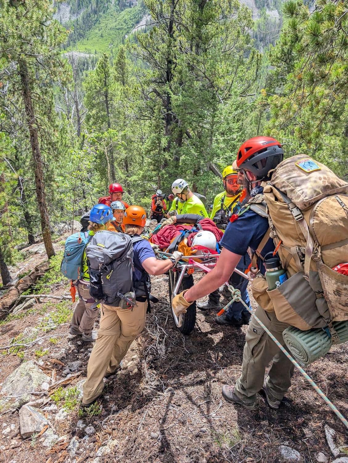 Search and rescue teams used a litter on an all-terrain wheel to bring a stricken hiker to safety. The man had inadvertently been left behind on an office retreat hike.