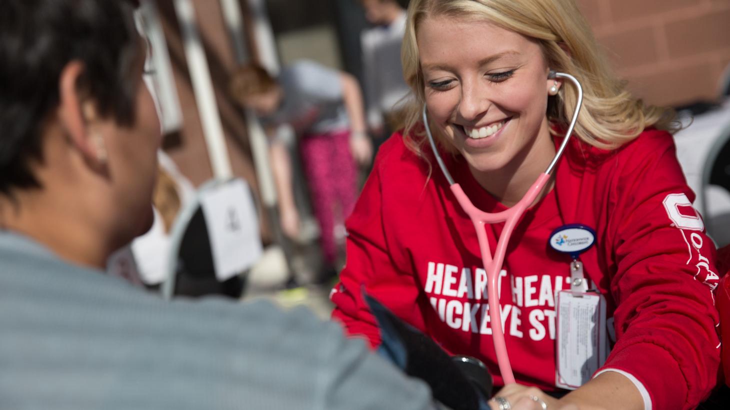 Instructor showing students how to check blood pressure