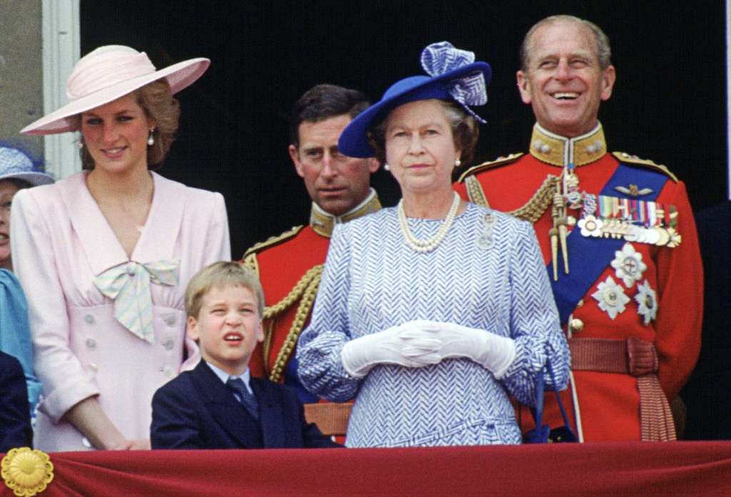 Queen Elizabeth II and her family watch the Trooping The Colour from Buckingham Palace.