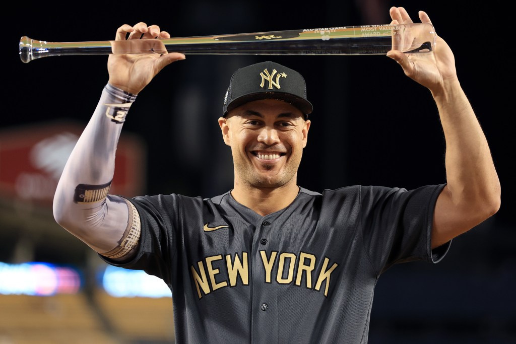 Giancarlo Stanton holds up the Ted Williams MVP Award during the 2022 MLB All-Star Game on Tuesday.