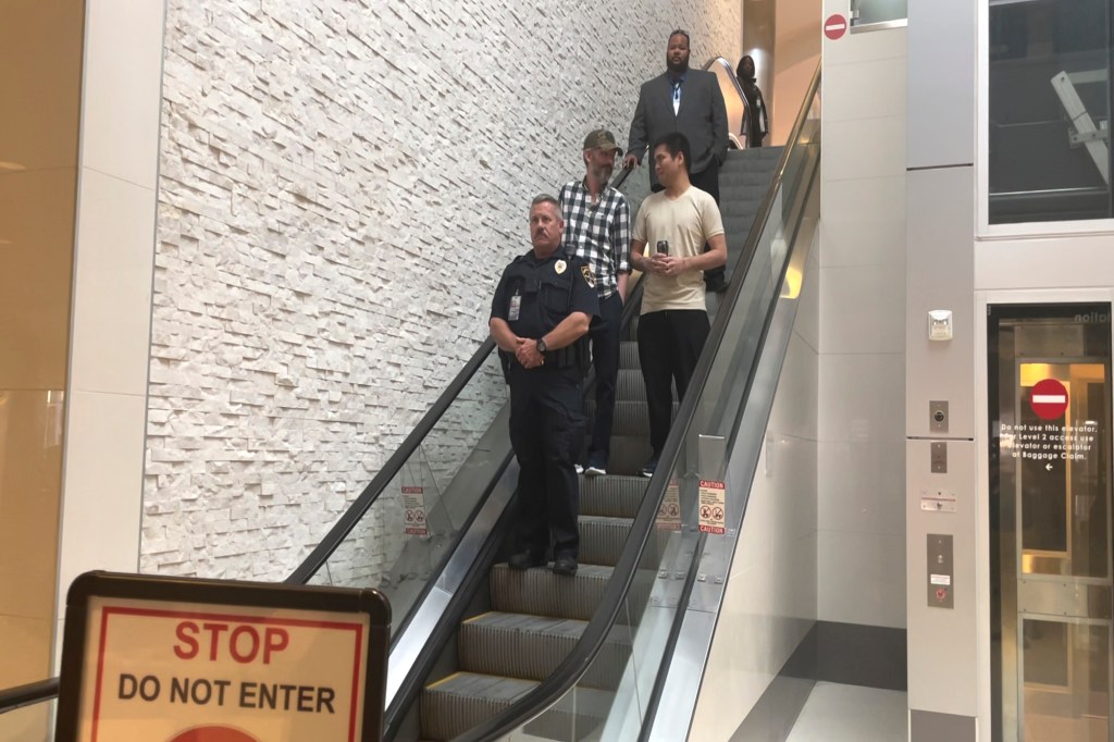 appeared at the top of an escalator at the Birmingham-Shuttlesworth International Airport in Birmingham