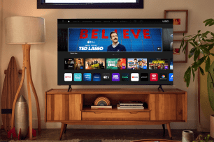 Vizio TV on a brown wooden TV stand