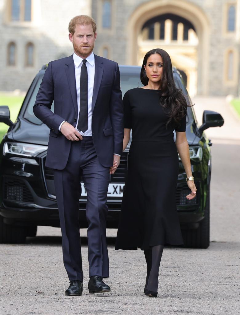 Prince Harry, Duke of Sussex, and Meghan, Duchess of Sussex arrive on the long Walk at Windsor Castle arrive to view flowers and tributes to HM Queen Elizabeth on September 10, 2022 in Windsor, England.